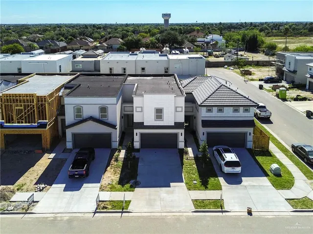 an aerial view of residential houses with outdoor space