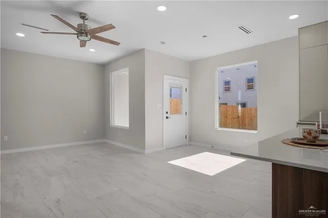 a kitchen with a sink window and cabinets
