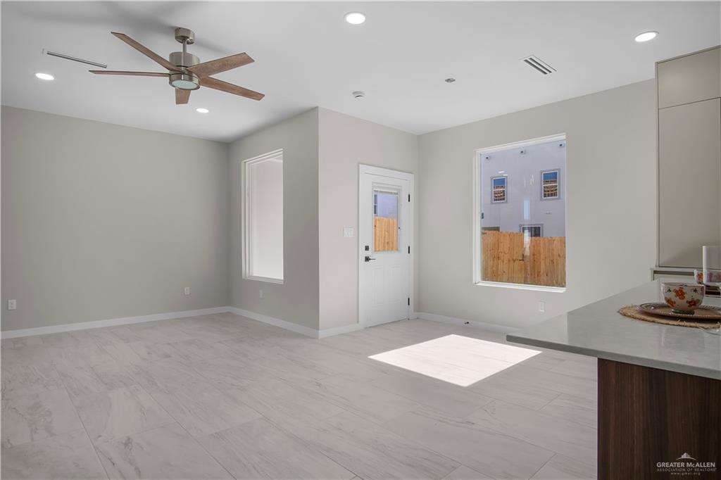 2204 Corales Street Mission, TX 78573 - Photo 6 of 30 a view of an empty room with a ceiling fan and a window