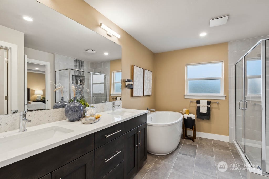 4020 171st Place Southeast Bothell, WA 98012 - Photo 20 of 35 a large bathroom with a double vanity sink a large mirror and a shower