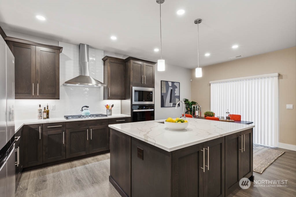 4020 171st Place Southeast Bothell, WA 98012 - Photo 3 of 35 a kitchen with kitchen island a sink appliances and cabinets