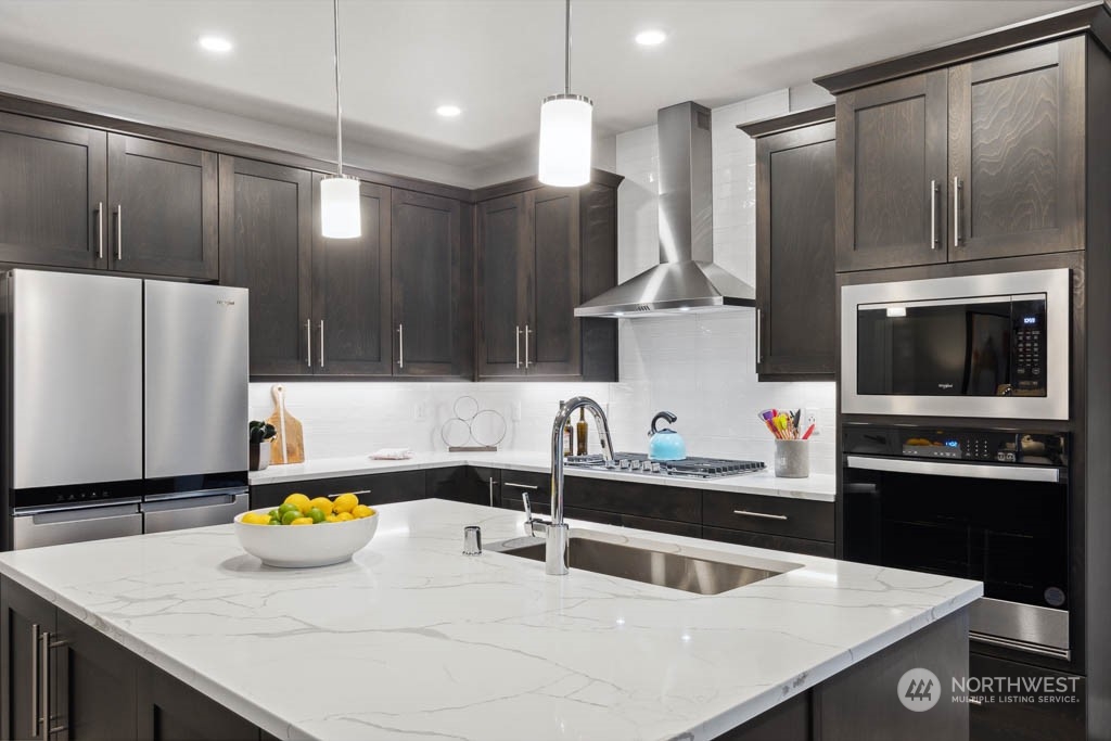 4020 171st Place Southeast Bothell, WA 98012 - Photo 5 of 35 a kitchen with stainless steel appliances a sink a stove and a refrigerator