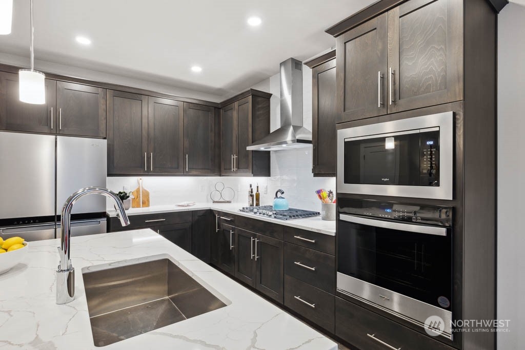 4020 171st Place Southeast Bothell, WA 98012 - Photo 6 of 35 a kitchen with a sink stove and microwave