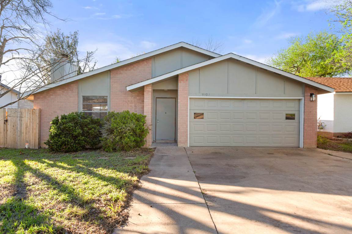 a view of backyard of house with garage