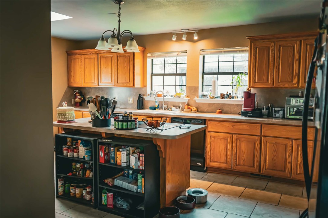 1014 Excelsior Road Greenwood, AR 72936 - Photo 24 of 37 Kitchen featuring wood cabinetry and an island with integrated shelving