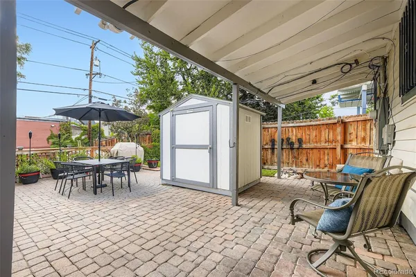 a view of a porch with furniture and a yard