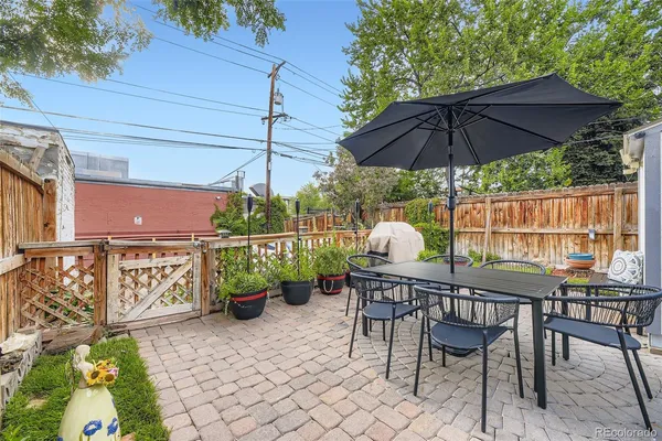 a table and chairs in patio of the house