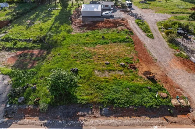 a backyard of a house with a yard and outdoor seating