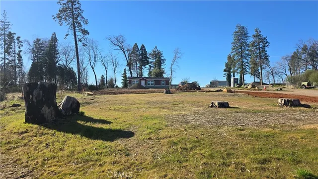 a view of yard with swimming pool and trees