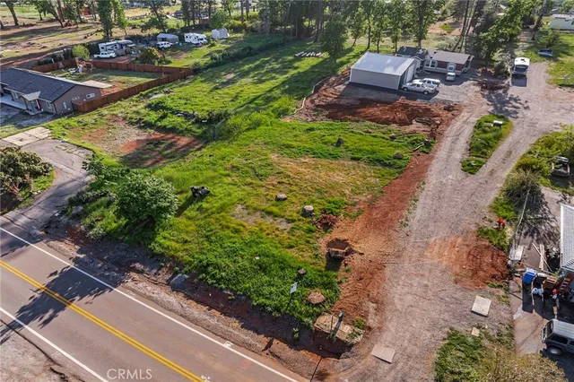 an aerial view of a house with a yard
