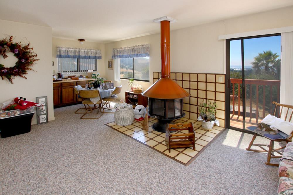53 Valley View Road Watsonville, CA 95076 - Photo 13 of 38 a living room with patio a couch and a dining table next to a window