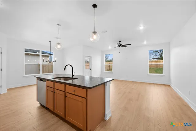 a kitchen with granite countertop a sink and a stove