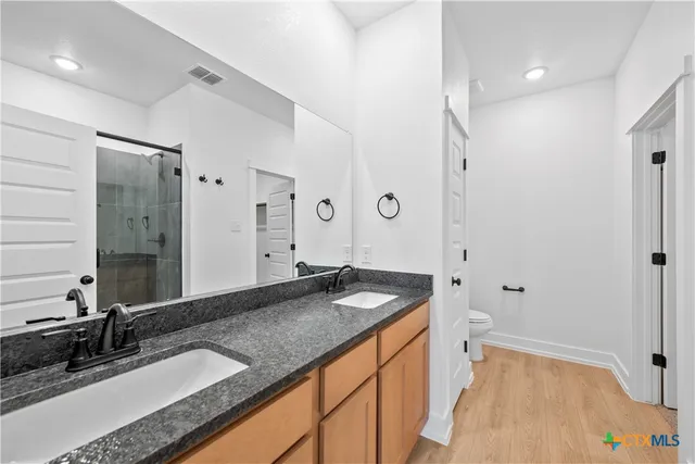 an empty room with windows and ceiling fan