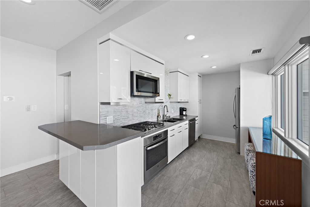 35585 Beach Road Dana Point, CA 92624 - Photo 19 of 43 a kitchen with granite countertop a sink stove and refrigerator