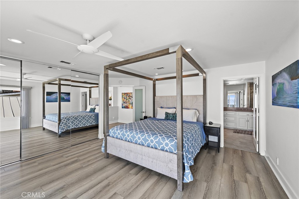 35585 Beach Road Dana Point, CA 92624 - Photo 26 of 43 a bedroom with a bed mirror and window