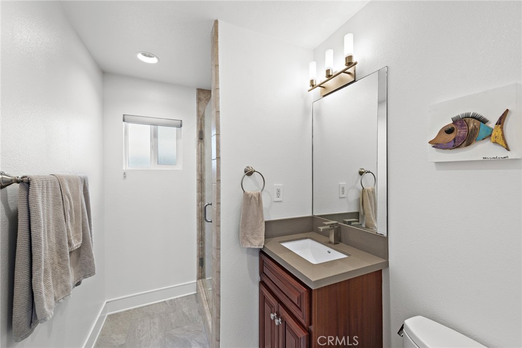 35585 Beach Road Dana Point, CA 92624 - Photo 33 of 43 a bathroom with a sink a toilet and shower