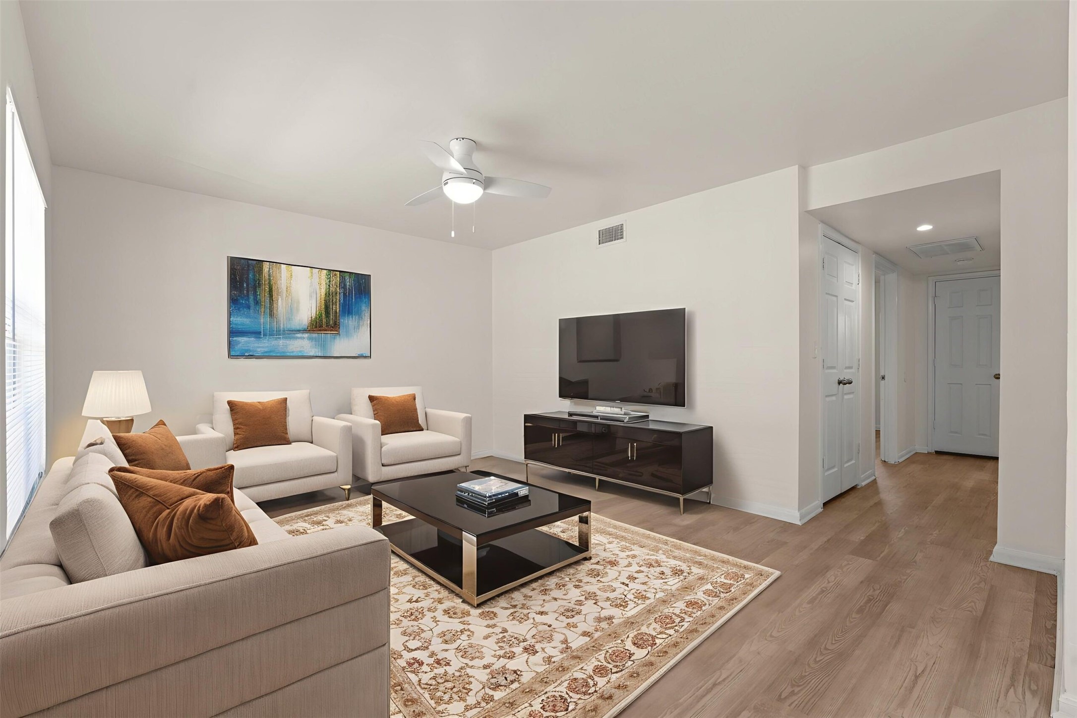 a living room with furniture and a flat screen tv