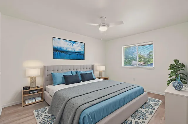 a bedroom with bed and paintings on the wall