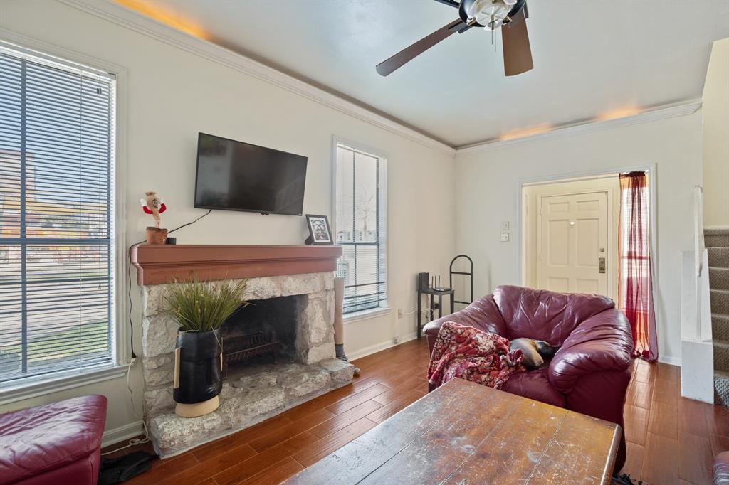 2529 Rio Grande Street, Unit 7 Austin, TX 78705 - Photo 2 of 13 a living room with furniture a fireplace and a flat screen tv