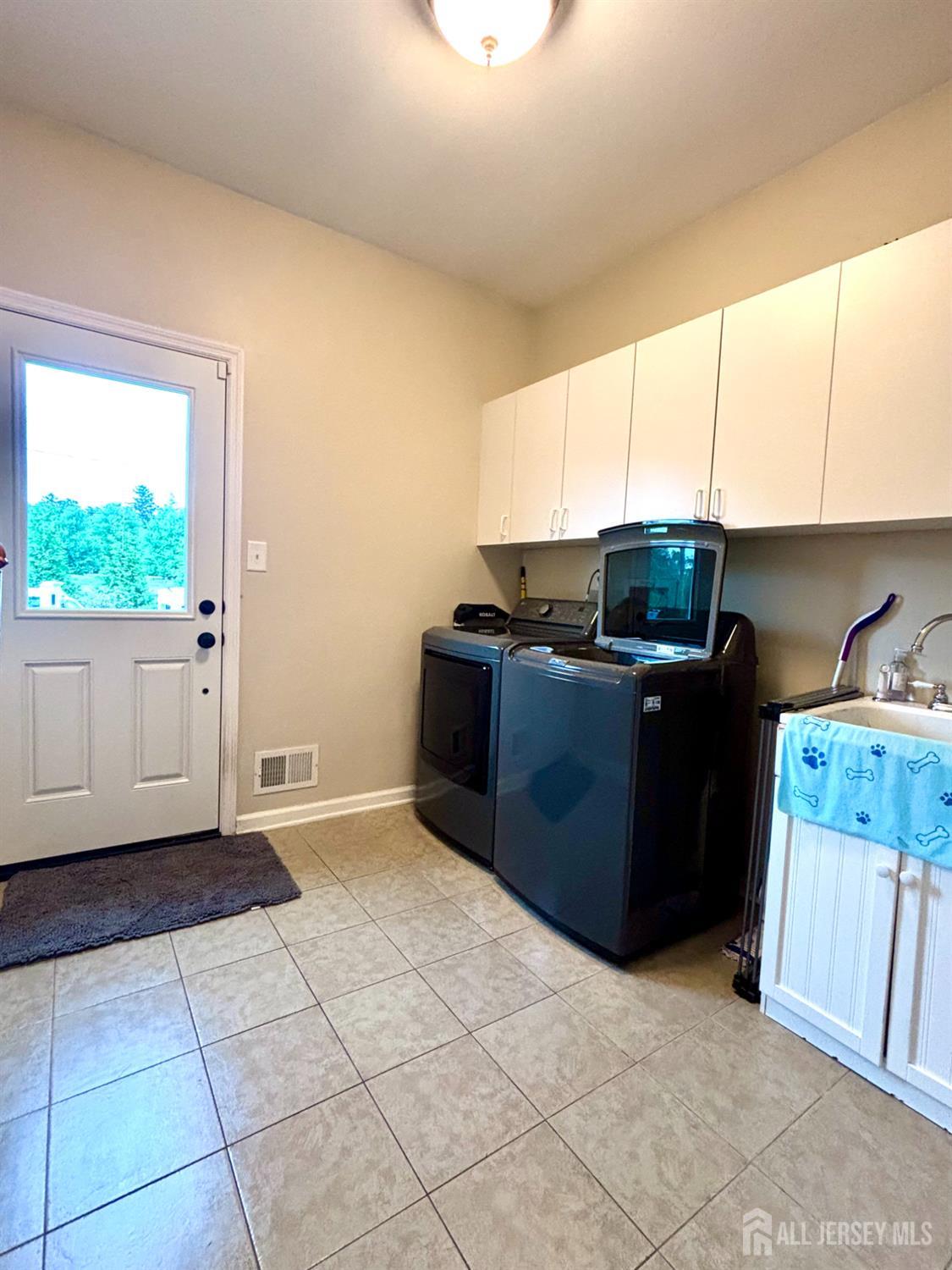 9 Pondview Drive Tinton Falls, NJ 07724 - Photo 24 of 41 a view of kitchen with refrigerator cabinets and window