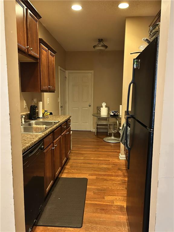 6354 Olmadison Place Atlanta, GA 30349 - Photo 2 of 8 a kitchen with stainless steel appliances a sink stove and refrigerator