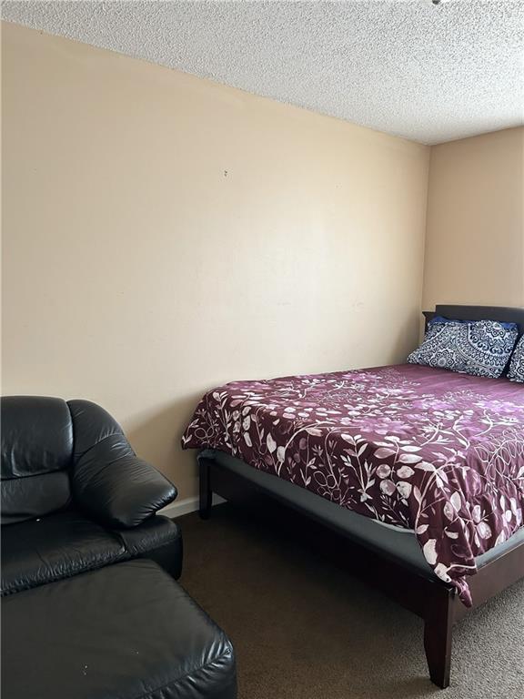 6354 Olmadison Place Atlanta, GA 30349 - Photo 7 of 8 a bedroom with a bed couch and a window