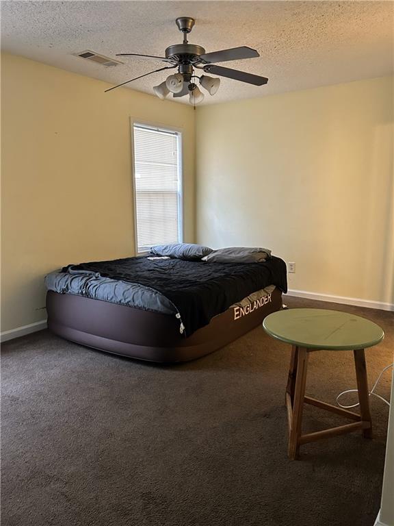 6354 Olmadison Place Atlanta, GA 30349 - Photo 8 of 8 a bedroom with a bed and a chandelier