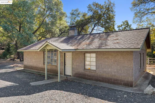 a view of a wooden house with a yard