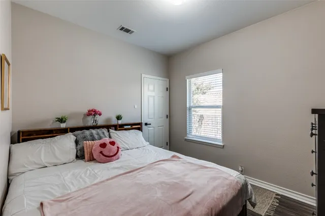 a bedroom with a bed and dresser
