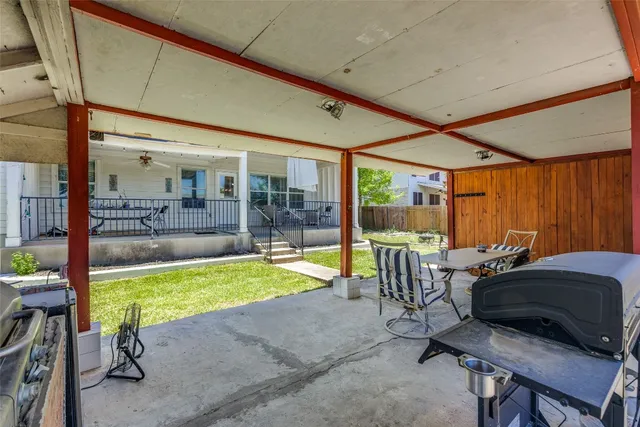 a view of a patio with table and chairs and potted plants