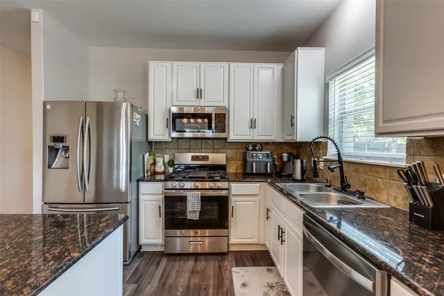 a kitchen with a sink stove and refrigerator