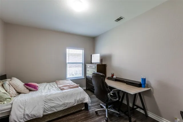 a bedroom with a bed and a desk