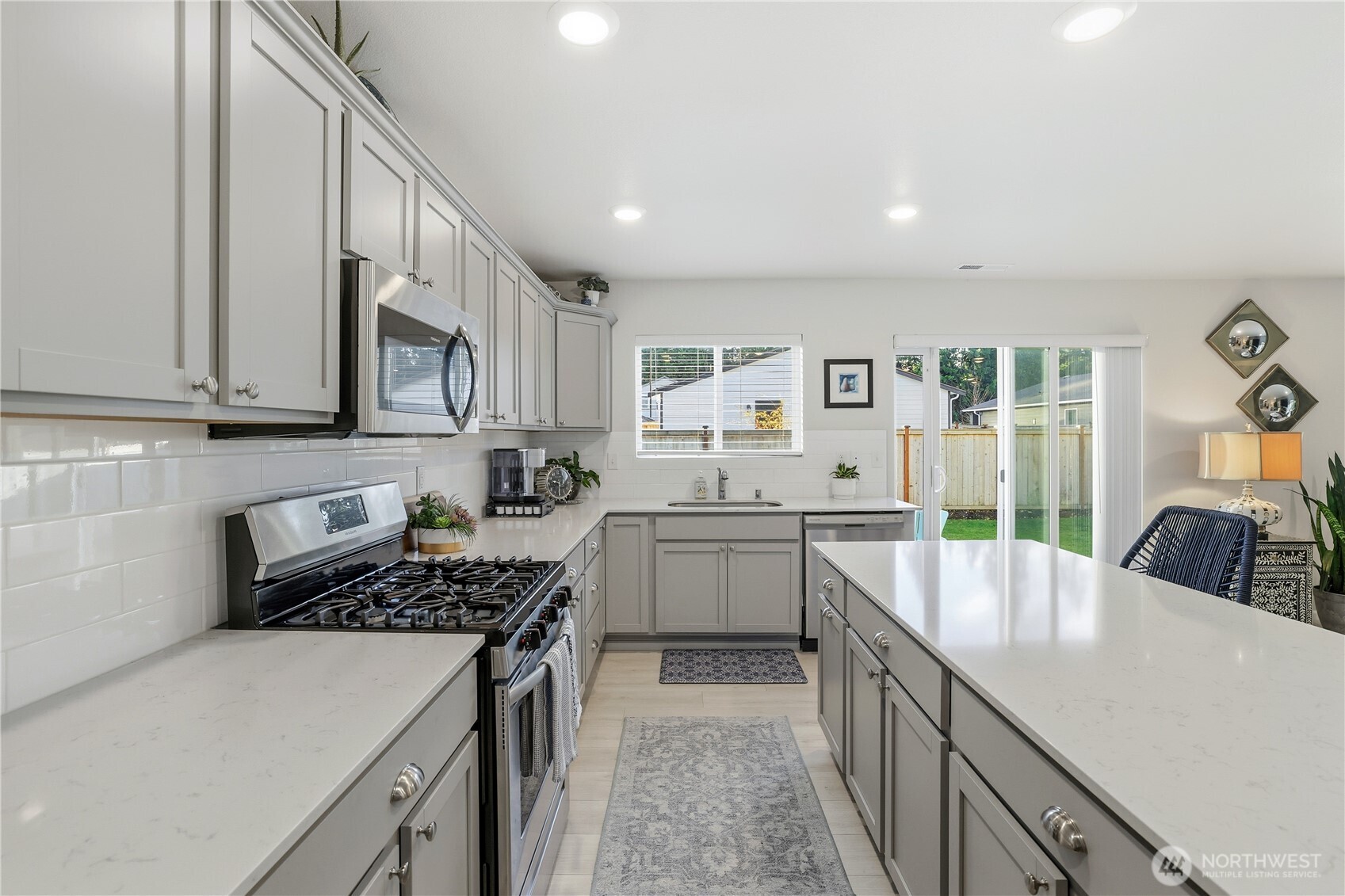 19908 135th Avenue East Graham, WA 98338 - Photo 13 of 39 a kitchen with counter top space cabinets and stainless steel appliances