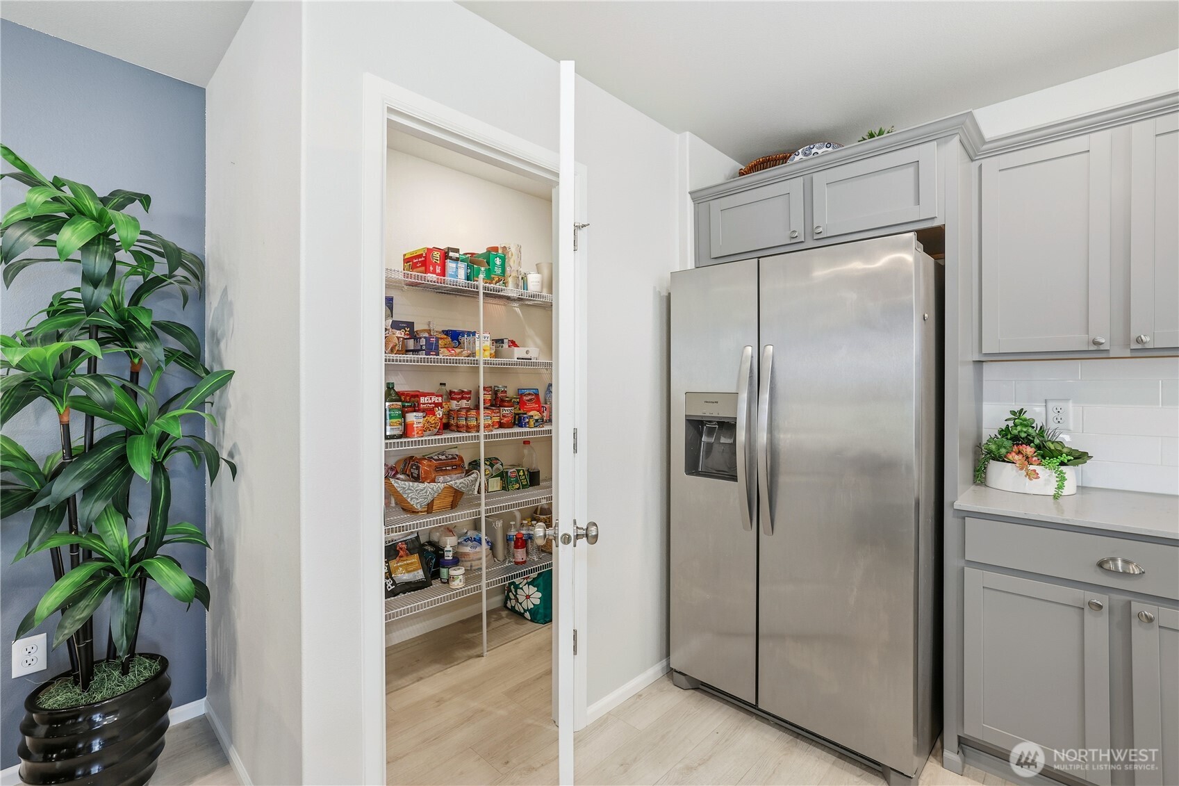 19908 135th Avenue East Graham, WA 98338 - Photo 16 of 39 a kitchen with refrigerator and a potted plant