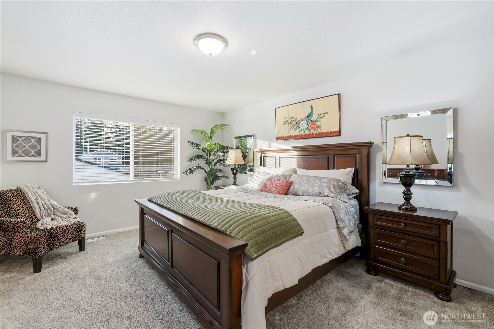 19908 135th Avenue East Graham, WA 98338 - Photo 19 of 39 a spacious bedroom with a bed a couch and a window