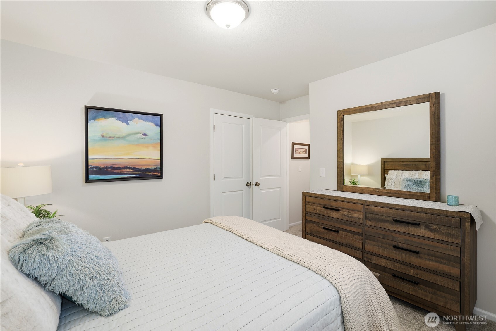 19908 135th Avenue East Graham, WA 98338 - Photo 26 of 39 a bedroom with a bed and a mirror on dresser