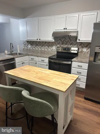 a kitchen with a stove and a cabinets
