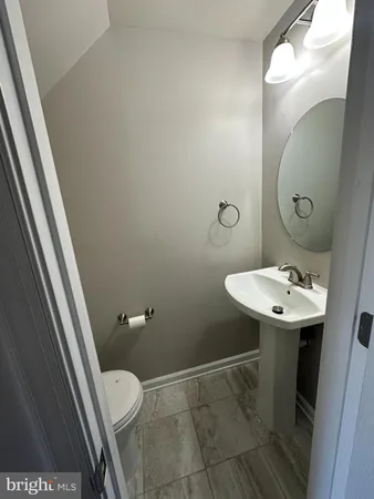 a bathroom with a sink a toilet a mirror and vanity
