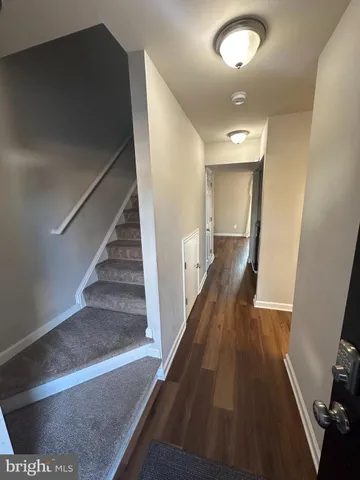 a view of entryway and hall with wooden floor