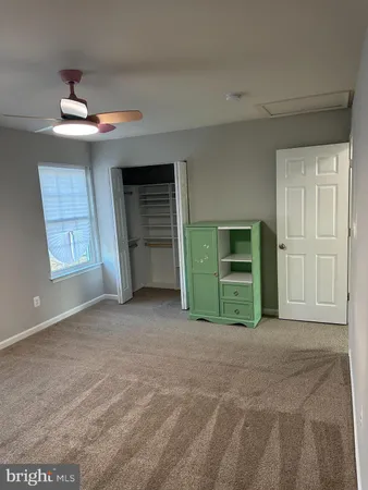 a view of an empty room with a fireplace and a window