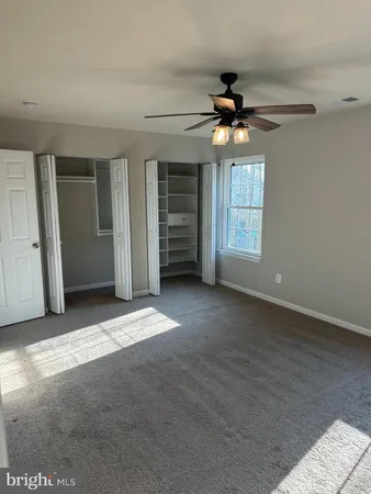 a view of a livingroom with a ceiling fan and window