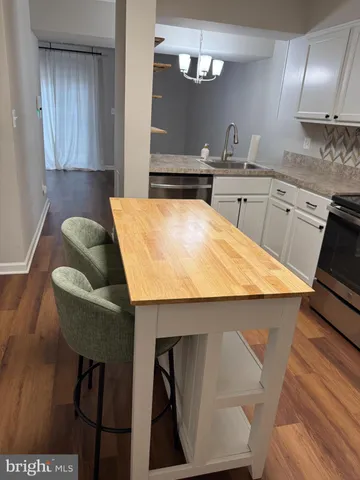 a kitchen with kitchen island a counter space and cabinets