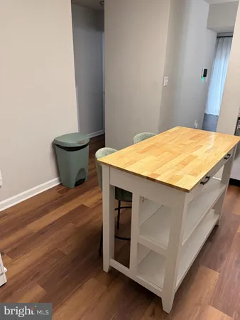 a room with a bed and wooden floor