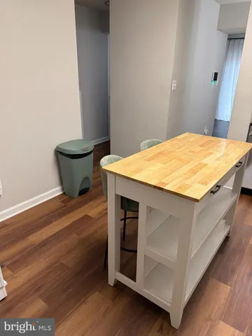 a room with a bed and wooden floor