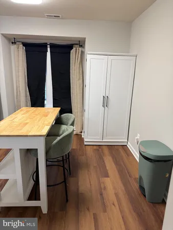 a view of a room with wooden floor and chair