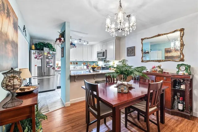 a view of a dining room with furniture wooden floor and chandelier