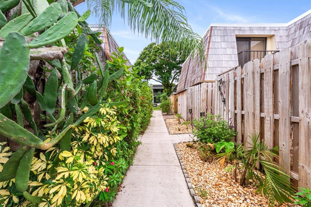 1170 6th Avenue, Unit 9D Vero Beach, FL 32960 - Photo 11 of 23 a view of a pathway with plants