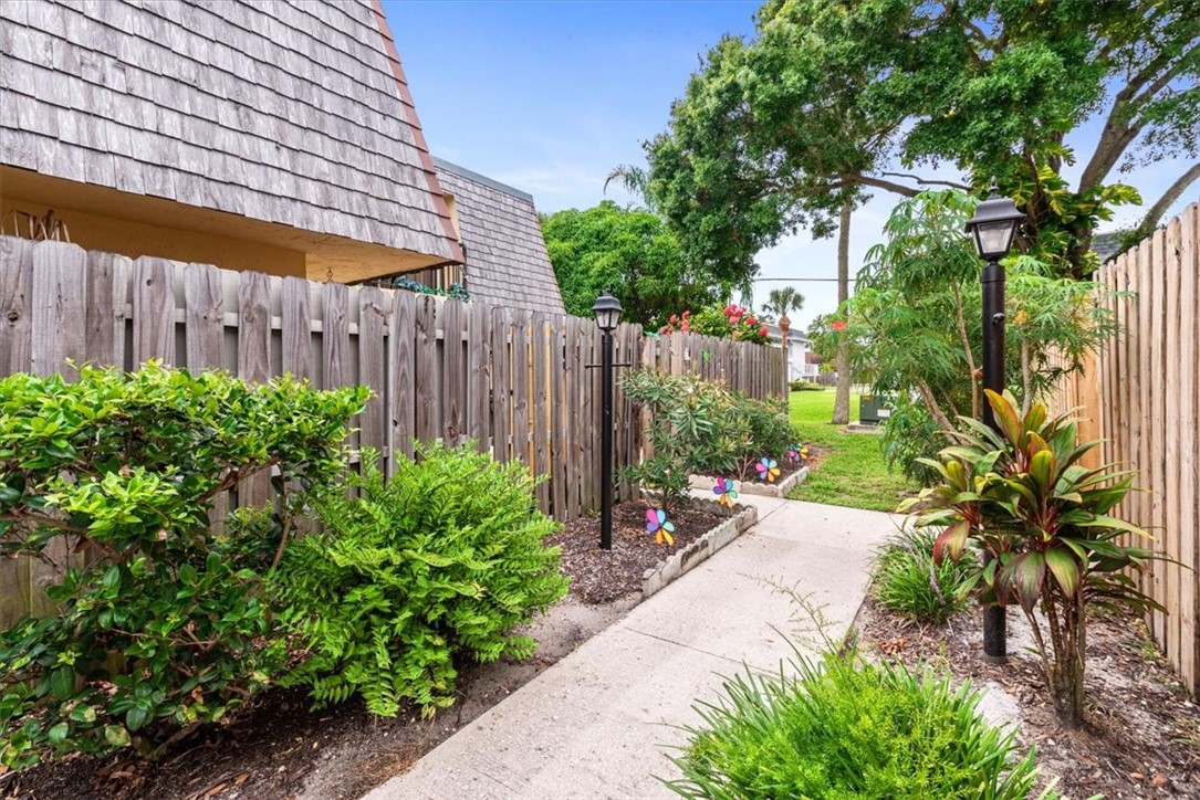 1170 6th Avenue, Unit 9D Vero Beach, FL 32960 - Photo 12 of 23 a backyard of a house with a garden