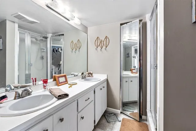 a spacious bathroom with a tub sink and mirror