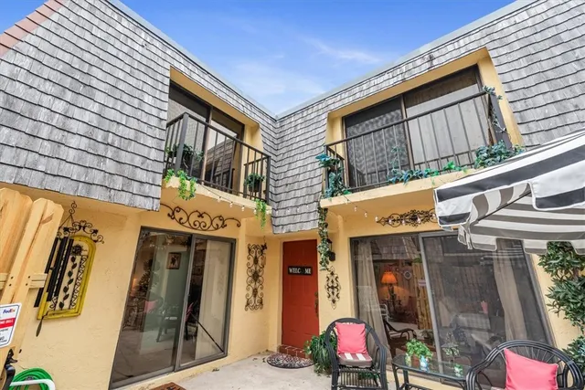 a backyard of a house with barbeque oven table and chairs